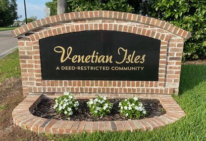 Venetian Isles Neighborhood sign with flowers